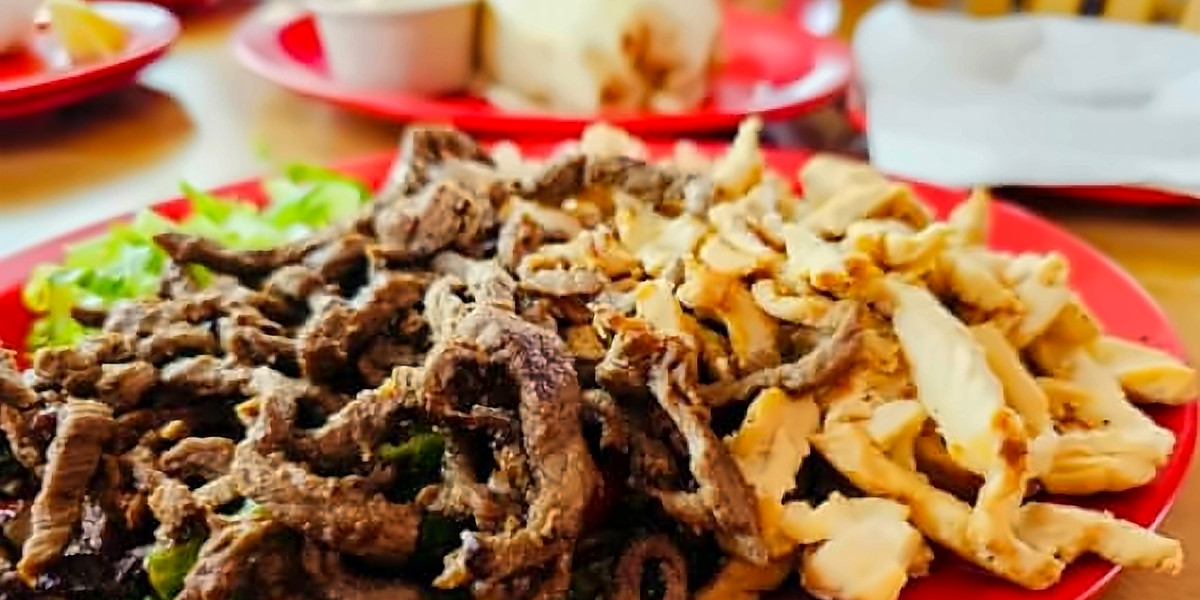 Grilled steak and chicken on a red plate