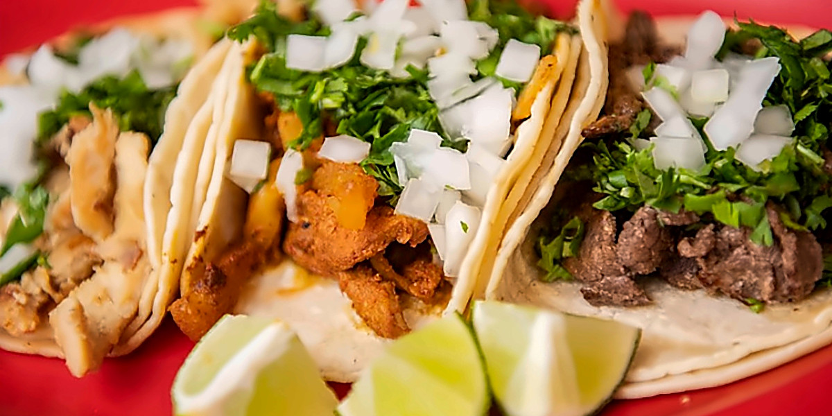 Chicken, al pastor and steak tacos with lime
